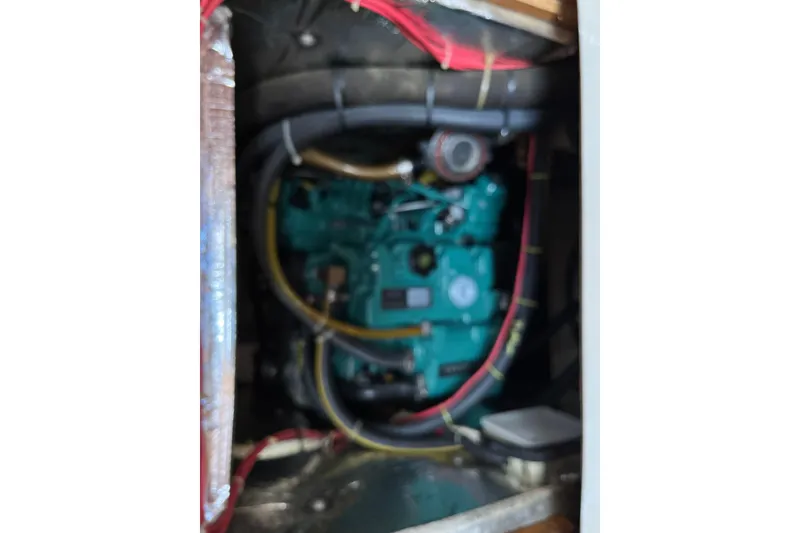 Slide: The Image of Engine compartment of a 1986 Wauquiez Petorine sailboat, featuring wiring and components. - 24