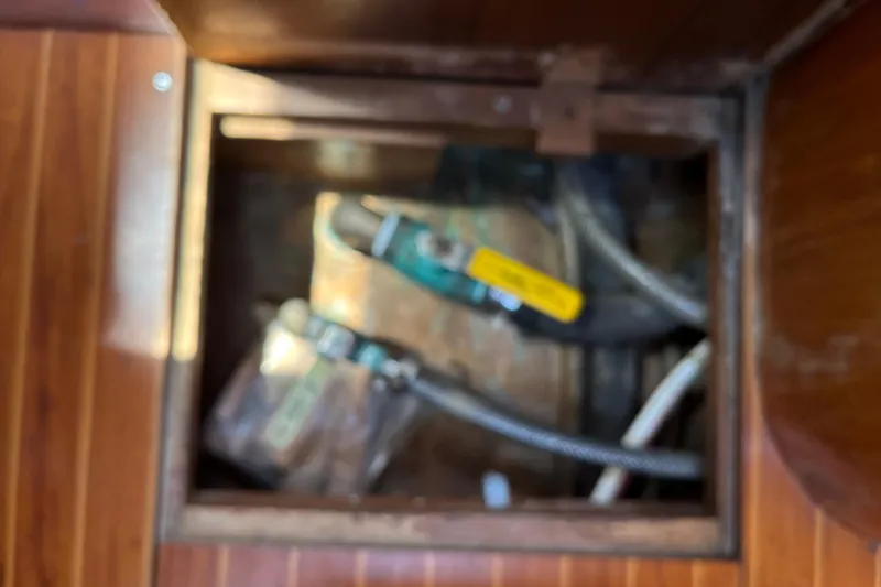 Slide: The Image of Access hatch with mechanical components inside a 1986 Wauquiez Petorine sailboat. - 26