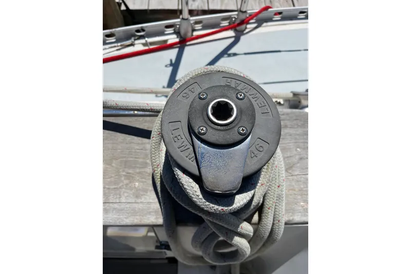 Slide: The Image of Winch on 1986 Wauquiez Petorine sailboat deck with coiled rope. - 27