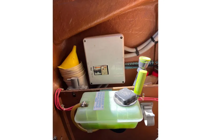 Slide: The Image of Electrical panel and fluid container inside a 1986 Wauquiez Petorine boat. - 28