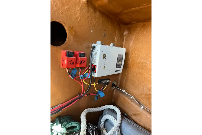Slide: The Image of Electrical setup in a 1986 Wauquiez Petorine boat, featuring a Xantrex Truecharge charger. - 29