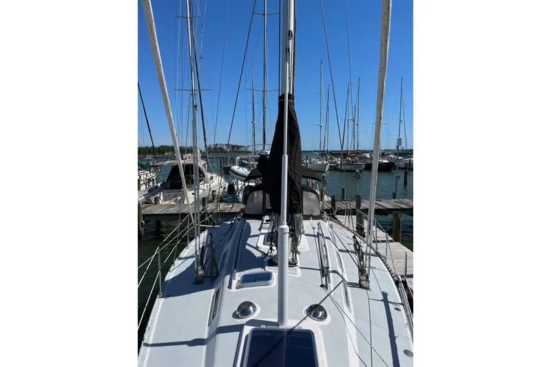 Slide: The Image of 1986 Wauquiez Petorine sailboat docked at marina under clear blue sky. - 30