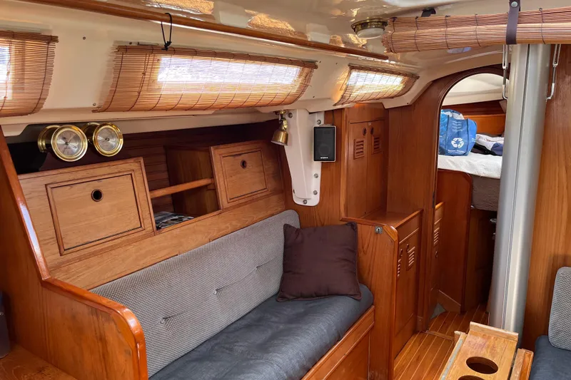 Slide: The Image of Interior of 1986 Wauquiez Petorine sailboat with wooden furnishings and cozy seating. - 8
