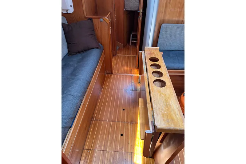 Slide: The Image of Interior of 1986 Wauquiez Petorine sailboat with wooden flooring and seating. - 9