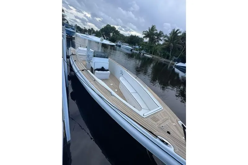 The Image of 2012 Novurania Chase boat docked on a calm waterway with palm trees. - 0