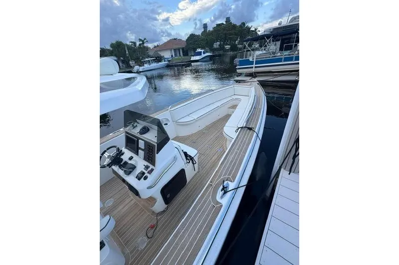 Slide: The Image of 2012 Novurania Chase boat docked, featuring sleek design and modern controls. - 6