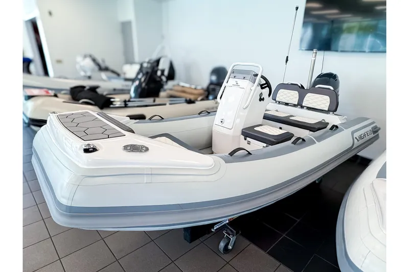 Slide: The Image of 2026 Highfield Sport 360 inflatable boat in a showroom. - 2