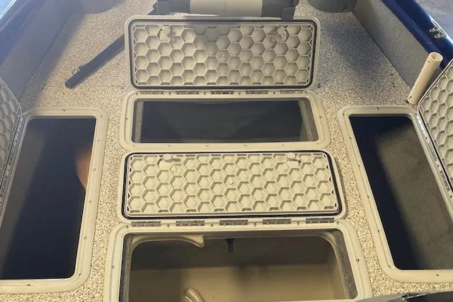 Slide: The Image of 2012 Bass Tracker Pro 17 boat storage compartments with hexagonal lids. - 12