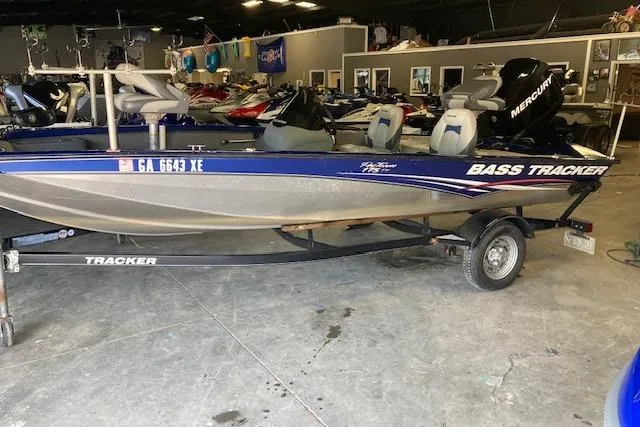 Slide: The Image of 2012 Bass Tracker Pro 17 boat with trailer in showroom setting. - 3