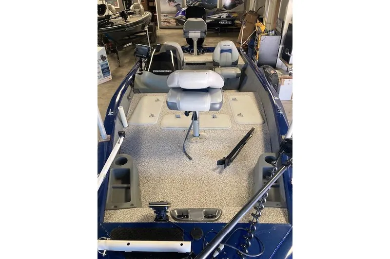 Slide: The Image of 2012 Bass Tracker Pro 17 boat interior with seating and storage compartments. - 6