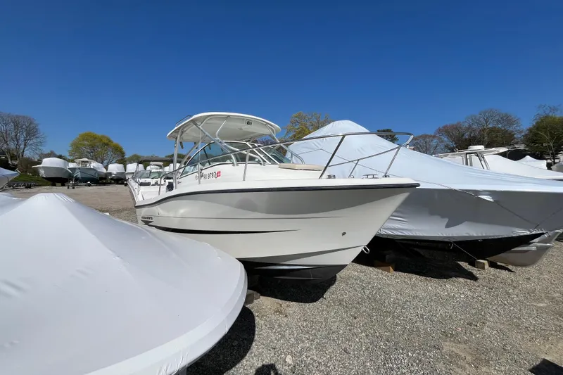 Slide: The Image of 2009 Hydra-Sports 2000 WA boat on gravel lot, surrounded by covered boats. - 22