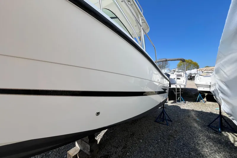 Slide: The Image of 2009 Hydra-Sports 2000 WA boat on stands, side view, in a marina setting. - 24