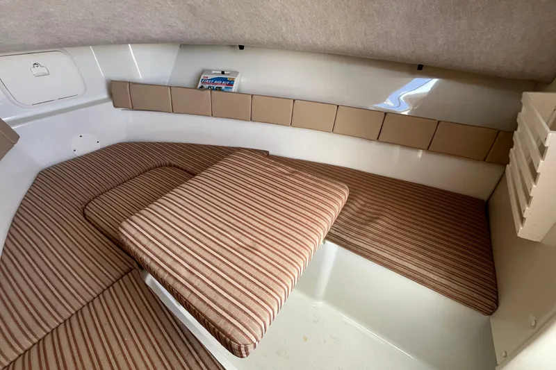 Slide: The Image of 2009 Hydra-Sports 2000 WA cabin interior with striped cushions and first aid kit. - 25