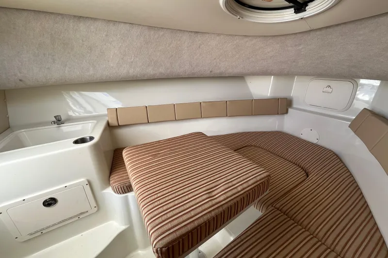Slide: The Image of Interior cabin of a 2009 Hydra-Sports 2000 WA boat with striped cushions and compact sink. - 26