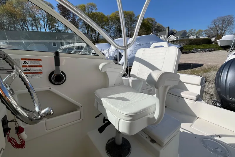 Slide: The Image of 2009 Hydra-Sports 2000 WA boat interior with steering wheel and white captain's chair. - 30