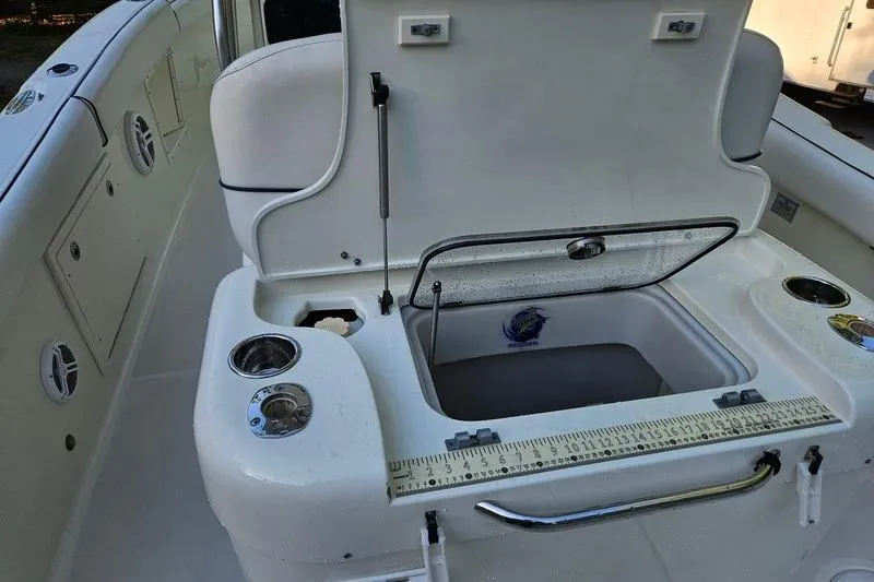 Slide: The Image of 2006 Hydra-Sports Vector 2900 CC boat with open storage compartment and measuring ruler. - 13