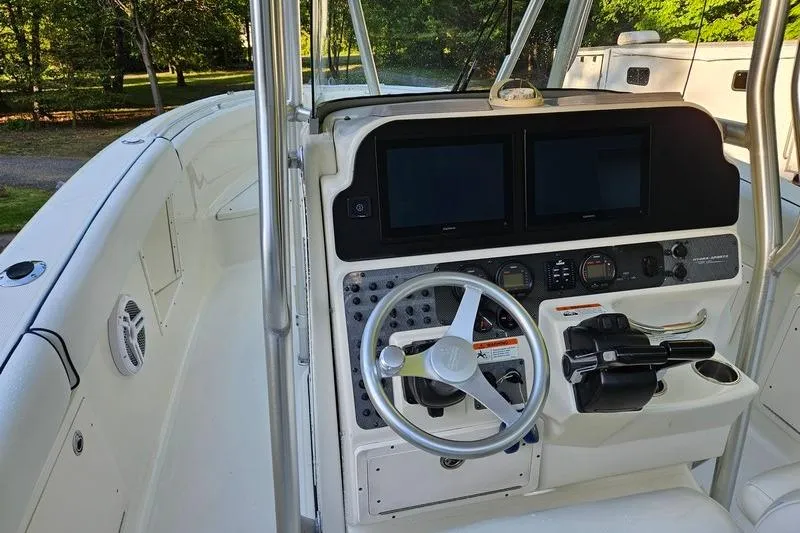 Slide: The Image of 2006 Hydra-Sports Vector 2900 CC boat cockpit with steering wheel and dual displays. - 15