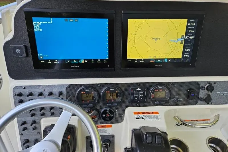 Slide: The Image of 2006 Hydra-Sports Vector 2900 CC dashboard with Garmin navigation displays and controls. - 18