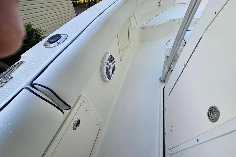 Slide: The Image of 2006 Hydra-Sports Vector 2900 CC boat interior, featuring white seating and speaker. - 21