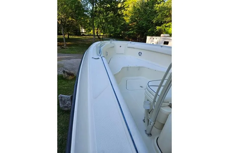Slide: The Image of 2006 Hydra-Sports Vector 2900 CC boat, white interior, docked in a lush green setting. - 22