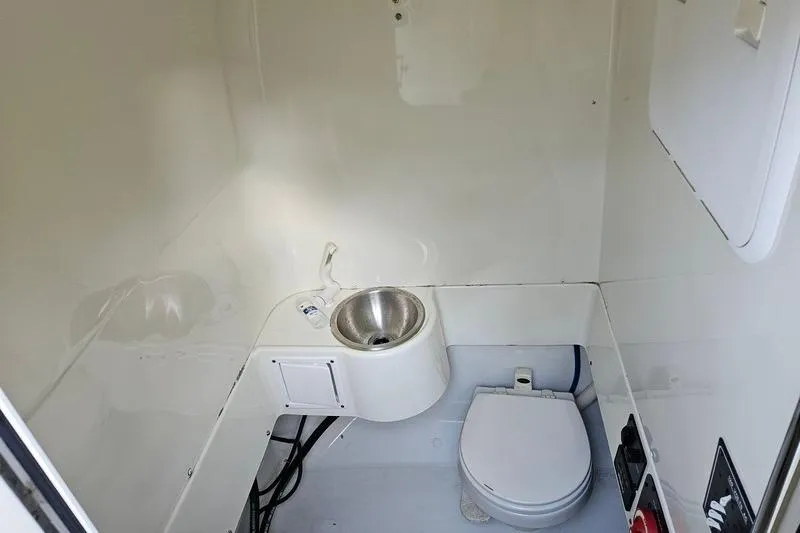 Slide: The Image of 2006 Hydra-Sports Vector 2900 CC boat interior with compact marine toilet and sink. - 23