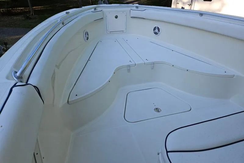 Slide: The Image of 2006 Hydra-Sports Vector 2900 CC boat interior, featuring spacious white deck and storage compartments. - 26