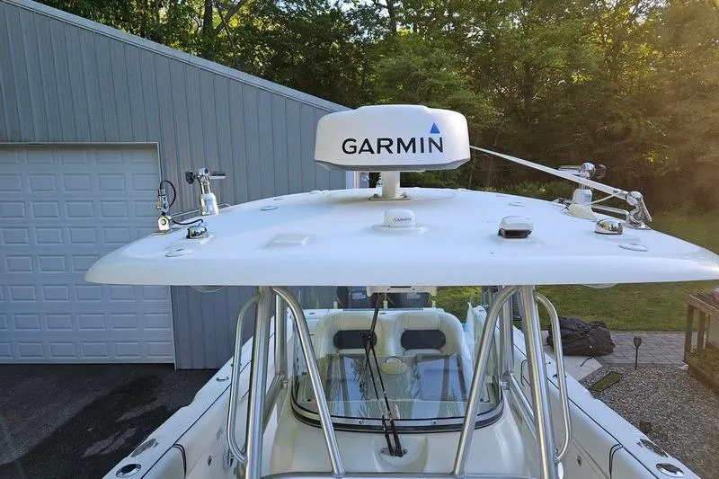 Slide: The Image of 2006 Hydra-Sports Vector 2900 CC boat with Garmin radar, parked near a garage. - 30