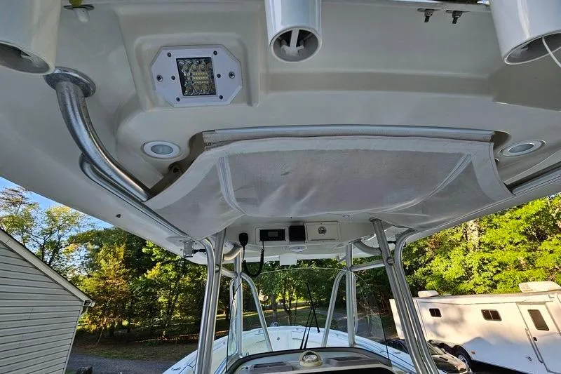 Slide: The Image of 2006 Hydra-Sports Vector 2900 CC boat interior, featuring rod holders and overhead storage. - 35