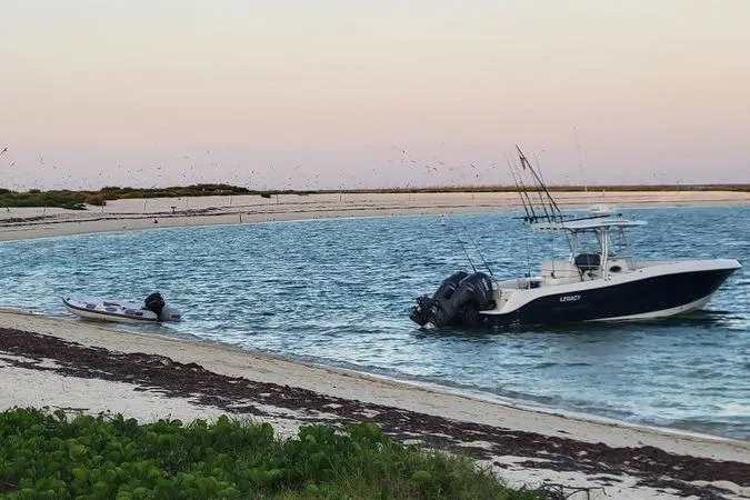 Slide: The Image of 2006 Hydra-Sports Vector 2900 CC boat anchored near a sandy beach at sunset. - 4