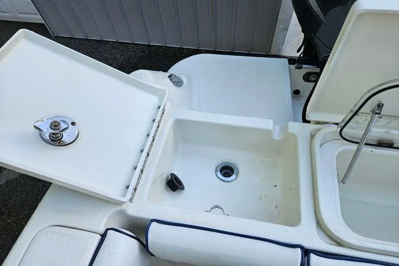 Slide: The Image of 2006 Hydra-Sports Vector 2900 CC boat deck with open storage compartments. - 40