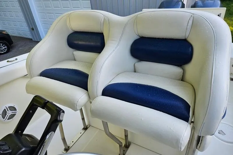 Slide: The Image of 2006 Hydra-Sports Vector 2900 CC boat seats, white and blue, in a garage setting. - 42