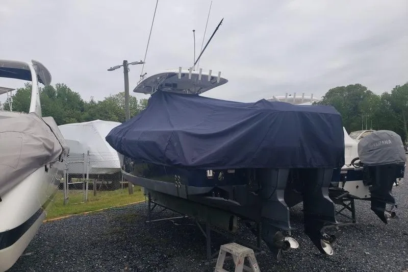 Slide: The Image of 2006 Hydra-Sports Vector 2900 CC boat covered, parked outdoors on gravel. - 48