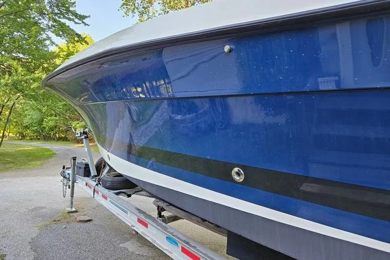 Slide: The Image of 2006 Hydra-Sports Vector 2900 CC boat on trailer, blue hull, parked outdoors. - 7