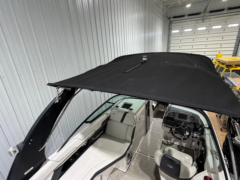 Slide: The Image of Interior view of a 2016 Regal 24 FasDeck RX boat with black canopy. - 13