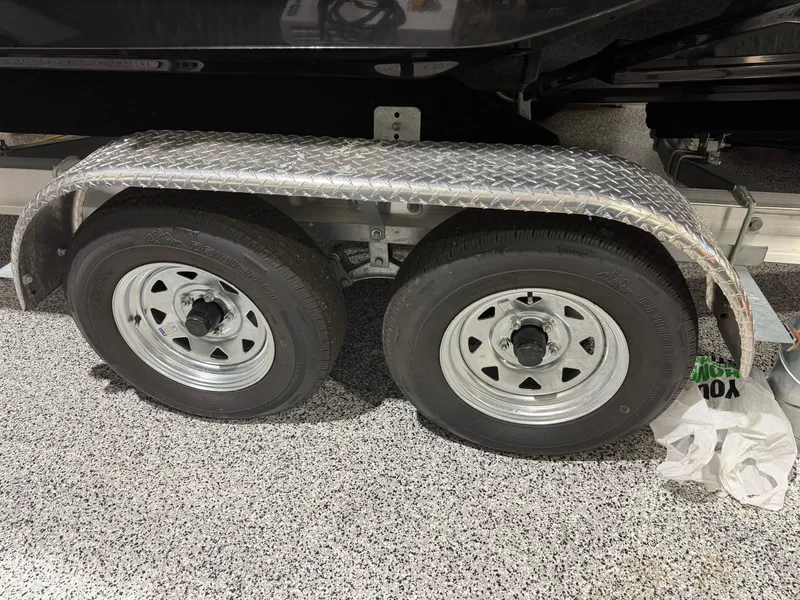 Slide: The Image of Dual trailer wheels of a 2016 Regal 24 FasDeck RX boat. - 8