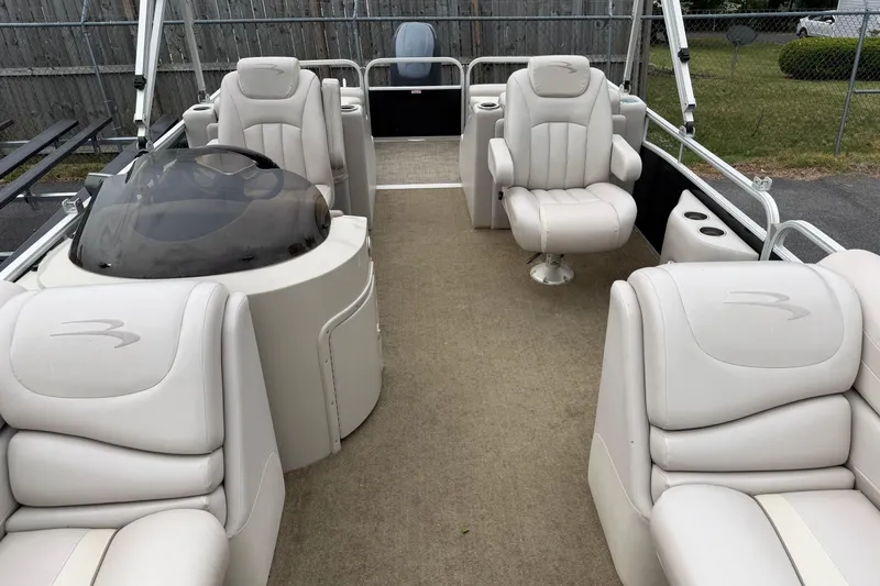 Slide: The Image of 2013 Bennington 2375 GCW pontoon boat interior with plush seating and helm. - 11