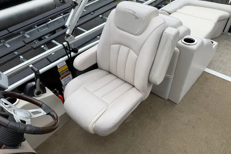Slide: The Image of Captain's chair on 2013 Bennington 2375 GCW pontoon boat, featuring plush white upholstery. - 12