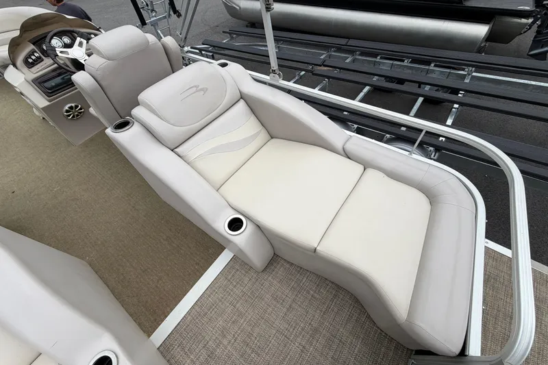Slide: The Image of 2013 Bennington 2375 GCW boat interior with luxurious beige seating and steering console. - 16