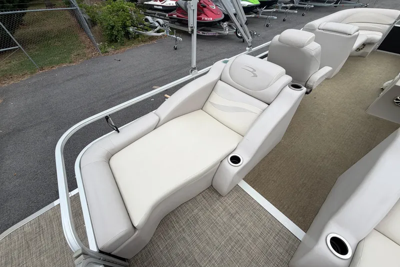 Slide: The Image of 2013 Bennington 2375 GCW boat interior with plush seating and cup holders. - 17