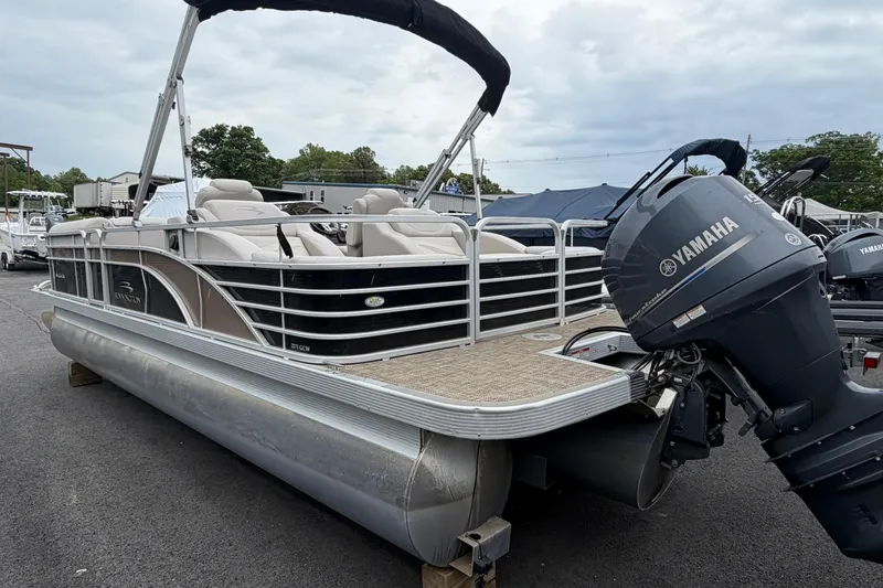 Slide: The Image of 2013 Bennington 2375 GCW pontoon boat with Yamaha outboard motor, parked outdoors. - 3