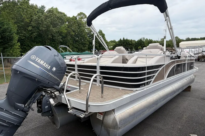 Slide: The Image of 2013 Bennington 2375 GCW pontoon boat with Yamaha outboard motor, parked outdoors. - 4