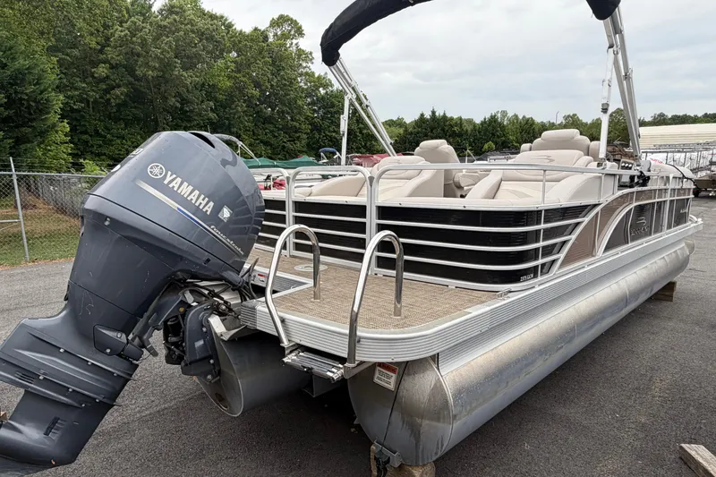 Slide: The Image of 2013 Bennington 2375 GCW pontoon boat with Yamaha outboard motor, parked outdoors. - 7