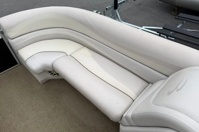 Slide: The Image of 2013 Bennington 2375 GCW boat interior with beige cushioned seating. - 8