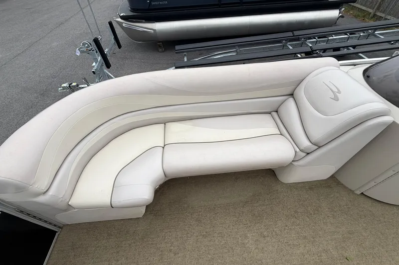 Slide: The Image of 2013 Bennington 2375 GCW boat with white cushioned seating on deck. - 9