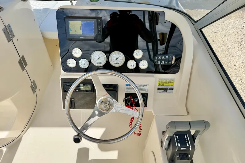 Slide: The Image of Steering console of 2007 World Cat 250 DC boat with gauges and controls. - 10