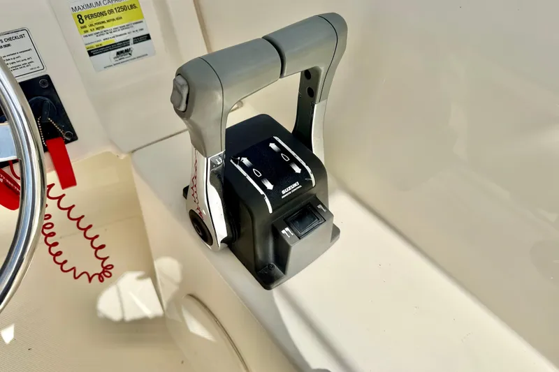 Slide: The Image of Throttle control on a 2007 World Cat 250 DC boat dashboard. - 15
