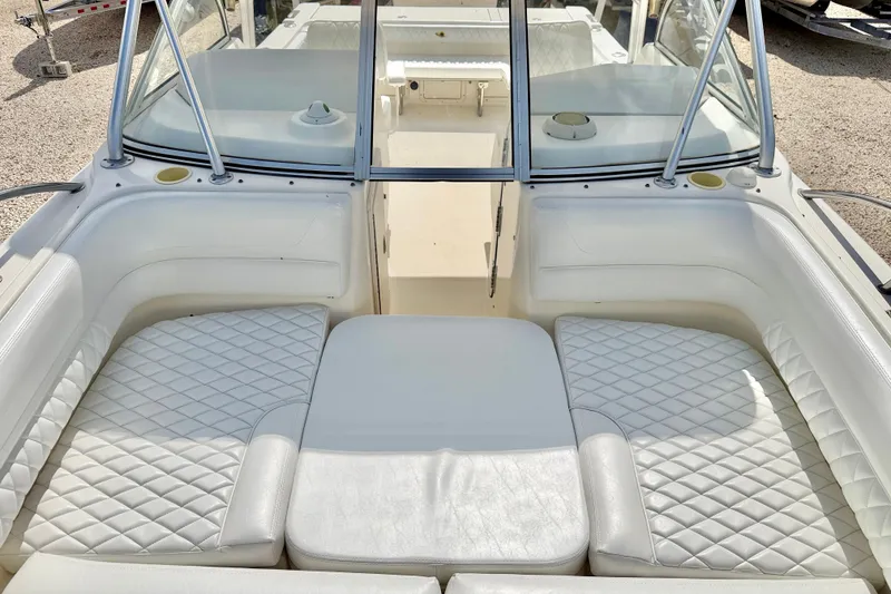 Slide: The Image of 2007 World Cat 250 DC boat interior with white cushioned seating and windshield. - 18