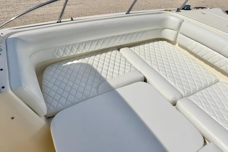 Slide: The Image of Luxurious white seating on a 2007 World Cat 250 DC boat, featuring diamond-pattern upholstery. - 21