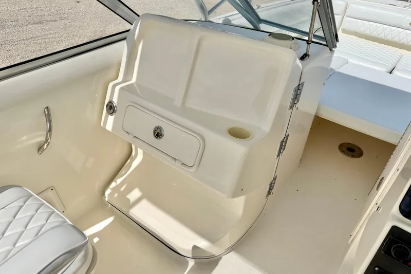 Slide: The Image of 2007 World Cat 250 DC boat interior with seating and storage compartment. - 22