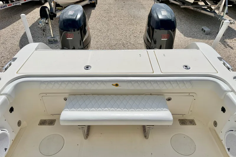 Slide: The Image of 2007 World Cat 250 DC boat with dual Suzuki 150 engines, featuring a cushioned bench seat. - 24